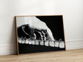Black and white scratchboard-style artwork of a pianist’s hand pressing piano keys, with bold line texture on a black background.
