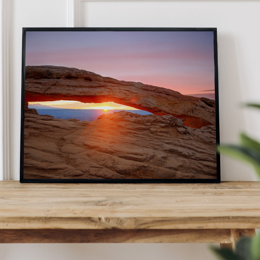 Golden sunrise seen through the iconic Mesa Arch, illuminating the arch's underside, Canyonlands National Park, Utah.