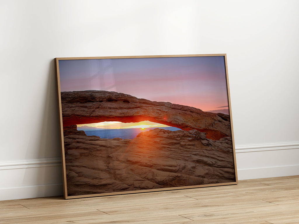 Golden sunrise seen through the iconic Mesa Arch, illuminating the arch's underside, Canyonlands National Park, Utah.